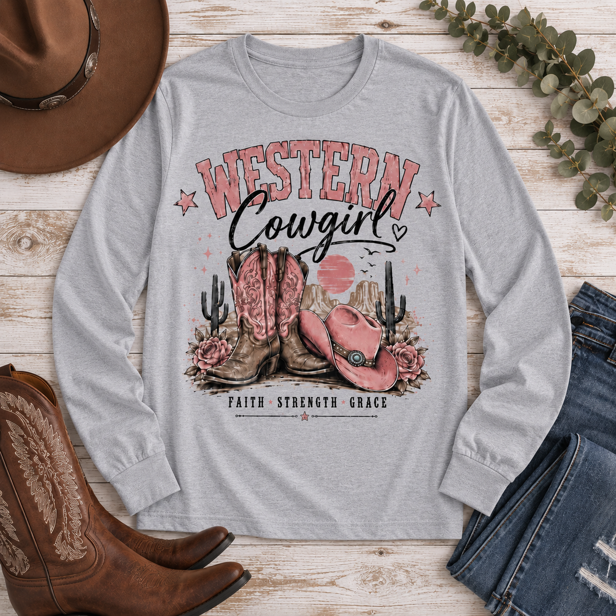 Western Cowgirl graphic long sleeve crewneck tee with pink boots, cowboy hat and desert design
