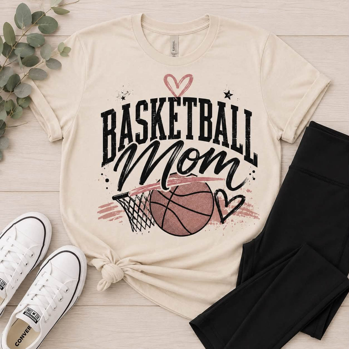 Neutral Basketball Mom crewneck T-shirt featuring a vintage basketball and hoop graphic with black stars and mauve heart accents.