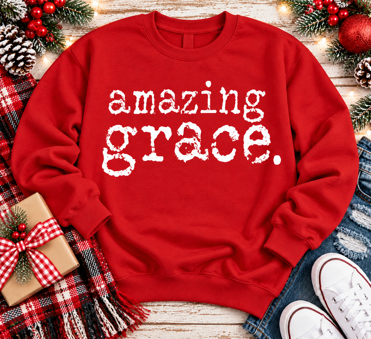 A red crewneck sweatshirt with the words 'amazing grace.' printed in a distressed white typewriter font across the chest.