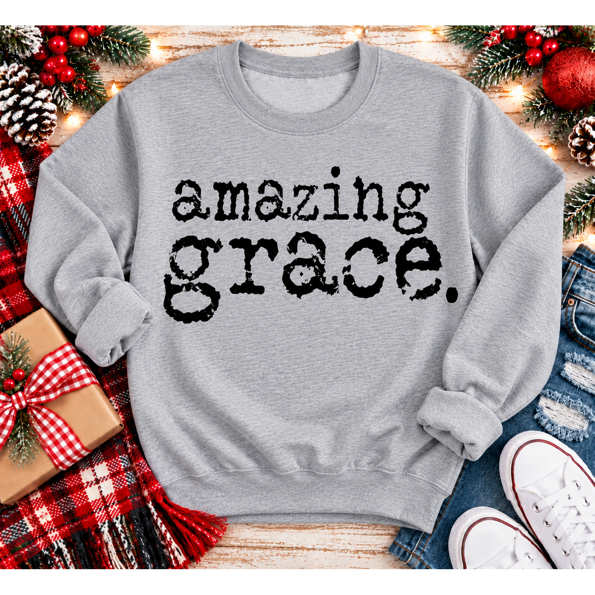 A light gray crewneck sweatshirt with the words 'amazing grace.' printed in a black distressed typewriter font.