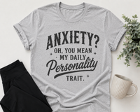 Gray graphic T-shirt with black vintage-style lettering reading Anxiety? Oh, You Mean My Daily Personality Trait.