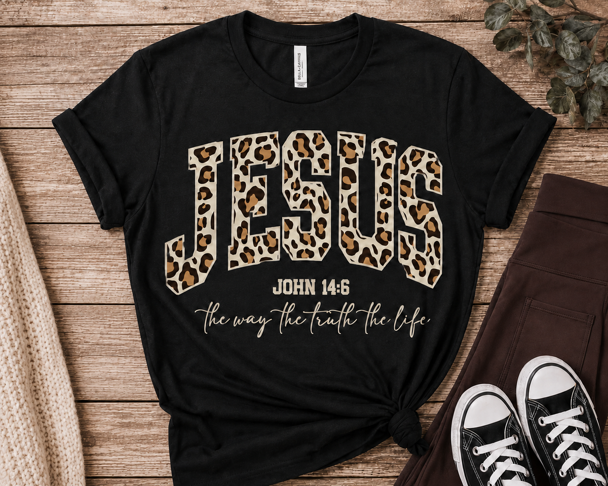 Black Jesus leopard-print John 14:6 graphic T-shirt displayed with chocolate-brown pocket leggings in a neutral year-round flat lay