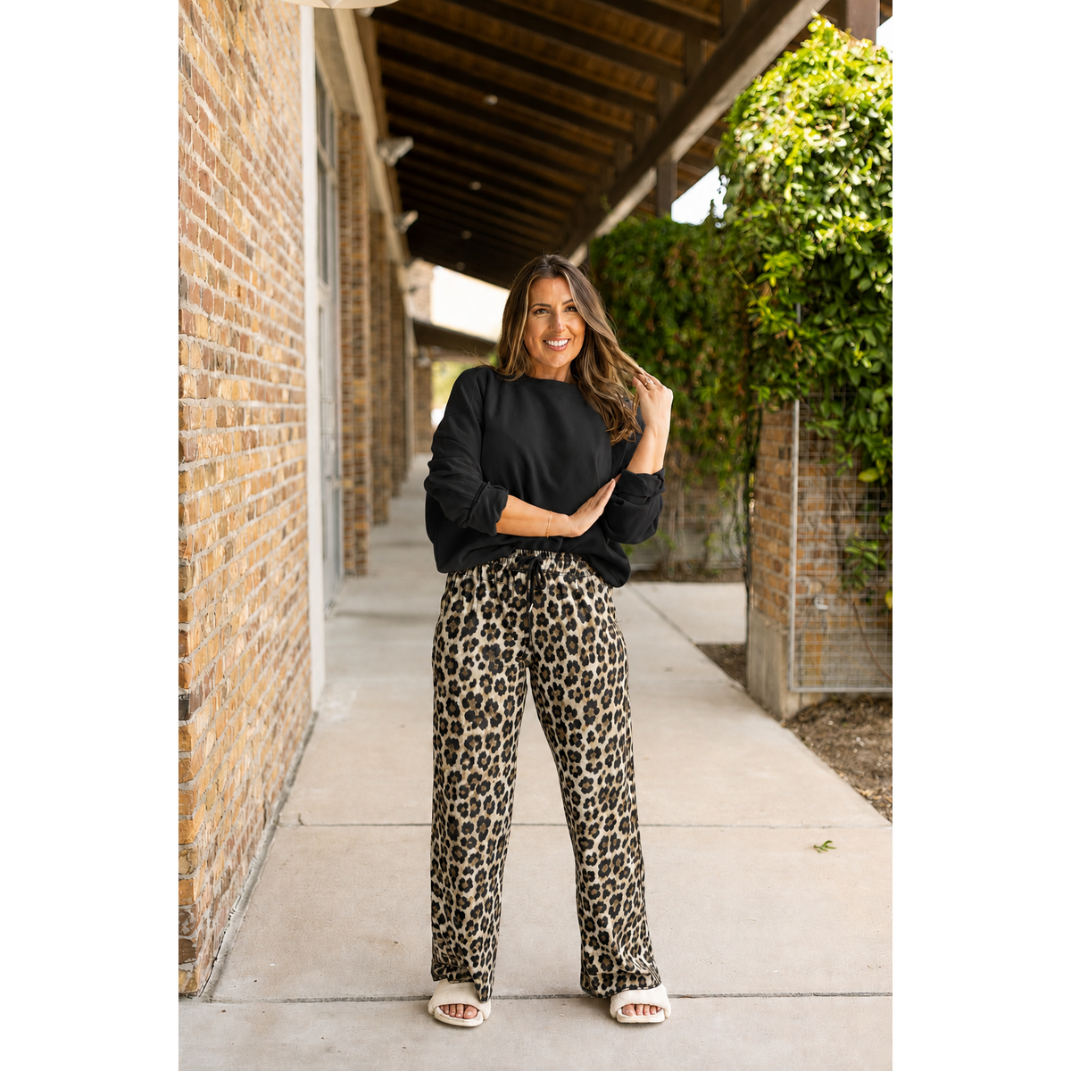 Model wearing The Tricia neutral leopard-print wide-leg pajama pants with a black sweatshirt
