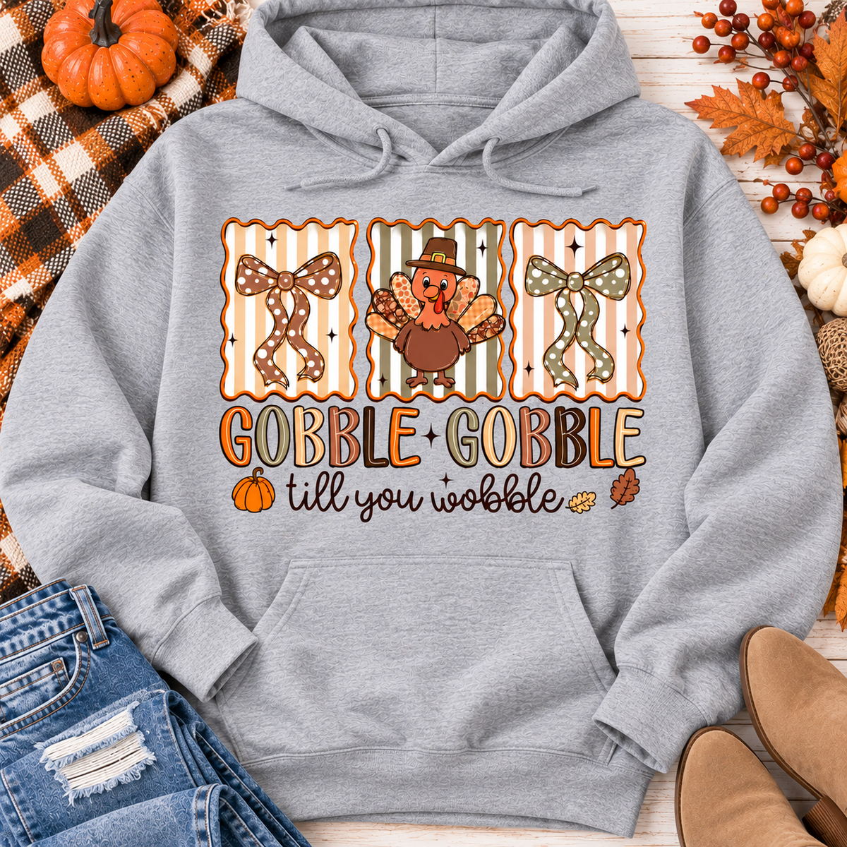 Gobble Gobble Till You Wobble Thanksgiving graphic apparel featuring a cute turkey, polka dot bows, retro fall colors, pumpkins and autumn leaves.