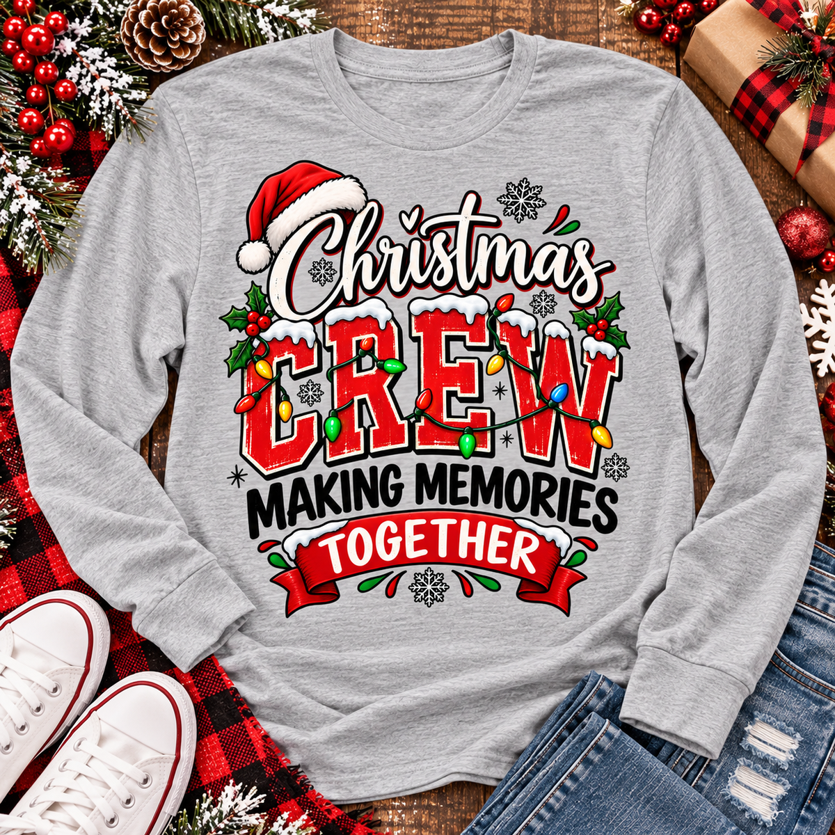 Christmas Crew Making Memories Together graphic on a pink crewneck T-shirt, featuring red lettering, colorful Christmas lights, a Santa hat, holly, and snowflakes.