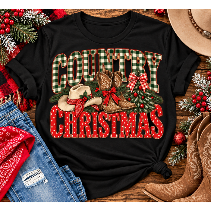 Country Christmas graphic tee with green plaid lettering, red polka dots, cowboy boots, western hat and festive Christmas bows.