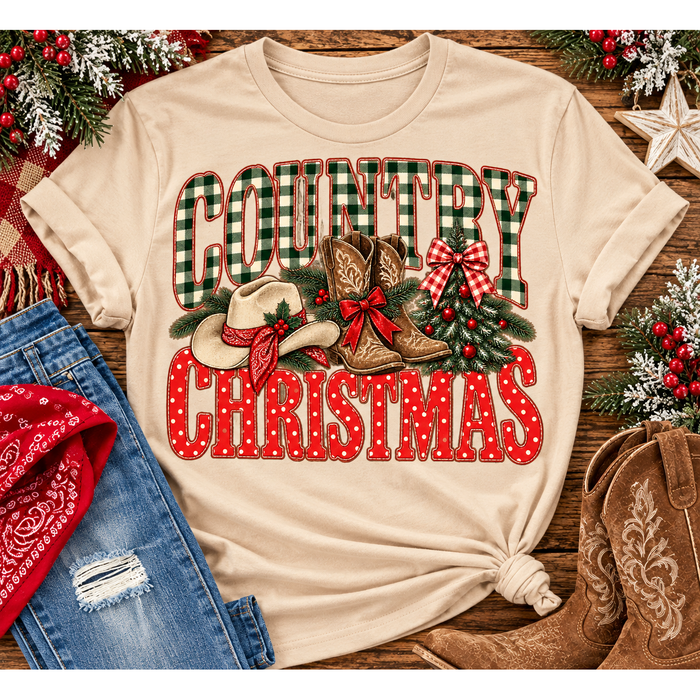 Country Christmas graphic tee with green plaid lettering, red polka dots, cowboy boots, western hat and festive Christmas bows.