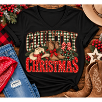 Country Christmas graphic tee with green plaid lettering, red polka dots, cowboy boots, western hat and festive Christmas bows.