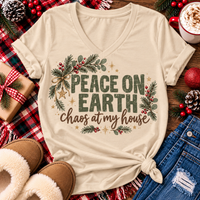 Peace on Earth Chaos at My House funny Christmas graphic apparel featuring distressed olive green lettering, rustic pine greenery, red berries and gold stars, available in sand and sport grey in short sleeve crewneck tees, V-neck tees, sweatshirts and hoodies.