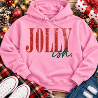 Jolly Ish Christmas graphic shirt featuring large distressed red JOLLY lettering with green handwritten ish script. Funny vintage-inspired holiday apparel available in pink and black, offered in short sleeve crewneck, V-neck, long sleeve and hoodie styles.