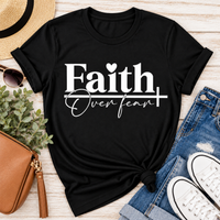 Faith Over Fear Christian inspirational graphic apparel featuring bold white Faith lettering, elegant Over Fear script, a small heart, and a cross design. Available in red and black in short sleeve crewneck, long sleeve crewneck, crewneck sweatshirt, and hoodie styles. Faith-based graphic clothing for women, everyday wear, church outfits, and inspirational gifts.