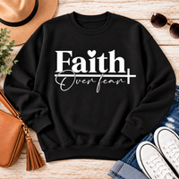 Faith Over Fear Christian inspirational graphic apparel featuring bold white Faith lettering, elegant Over Fear script, a small heart, and a cross design. Available in red and black in short sleeve crewneck, long sleeve crewneck, crewneck sweatshirt, and hoodie styles. Faith-based graphic clothing for women, everyday wear, church outfits, and inspirational gifts.