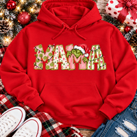 Christmas MAMA graphic shirt featuring pink and green patterned lettering, colorful holiday lights, and a Grinch-inspired character wearing a Santa hat.