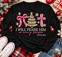 Christian Christmas shirt featuring I Will Praise Him in Every Season Psalm 146:2 graphic with pink bows, decorated Christmas tree, and cream snowflakes.