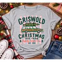 Christmas graphic tee featuring Griswold Christmas Tree Farm vintage green station wagon with Christmas tree and retro lettering.
