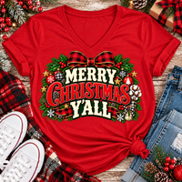 Merry Christmas Y'all graphic apparel featuring vintage red, green, and cream lettering with a festive buffalo plaid bow, Christmas ornaments, pine greenery, and rustic holiday decorations. Southern Christmas graphic available in two colors and four styles, including short sleeve crewneck, V-neck, long sleeve, and hoodie.