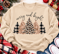 Merry and Bright Christmas graphic apparel featuring leopard print, buffalo plaid and glitter-inspired gold Christmas trees, available in three colors and four styles including crewneck tee, V-neck tee, sweatshirt and hoodie.