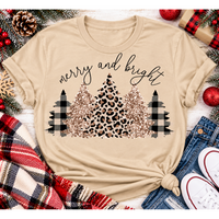 Merry and Bright Christmas graphic apparel featuring leopard print, buffalo plaid and glitter-inspired gold Christmas trees, available in three colors and four styles including crewneck tee, V-neck tee, sweatshirt and hoodie.