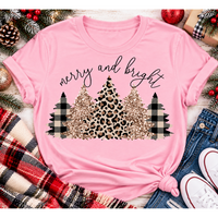 Merry and Bright Christmas graphic apparel featuring leopard print, buffalo plaid and glitter-inspired gold Christmas trees, available in three colors and four styles including crewneck tee, V-neck tee, sweatshirt and hoodie.