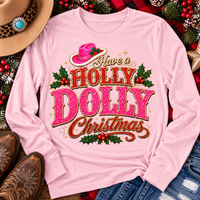 Have a Holly Dolly Christmas western graphic shirt featuring pink and red glitter-inspired lettering, a festive pink cowgirl hat, gold accents, and Christmas holly berries. Available in beige and pink in short sleeve crewneck, V-neck, long sleeve crewneck, and hoodie styles.
