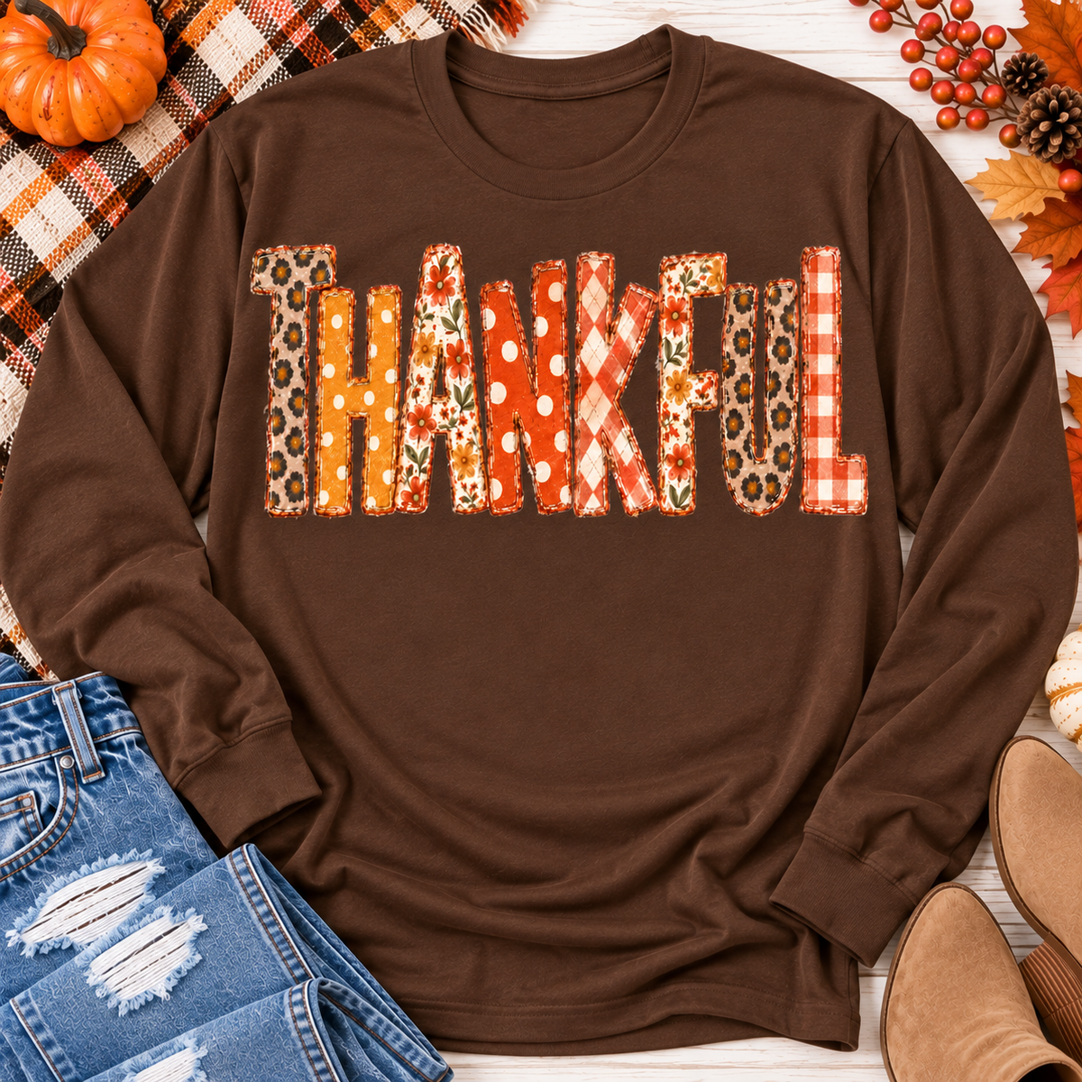 Brown long sleeve crewneck shirt featuring colorful Thankful patchwork lettering in retro autumn floral, plaid and polka dot patterns.