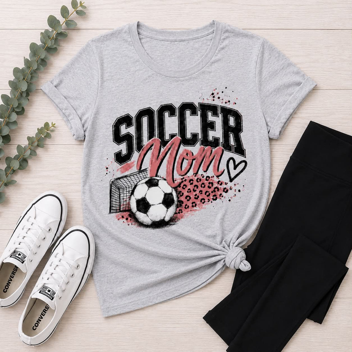 Gray crewneck Soccer Mom graphic tee with pink and black soccer ball, goal and leopard print design.