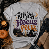 Gray Halloween graphic tee with It’s All Just a Bunch of Hocus Pocus lettering, cauldron, spell books, witch hat and bats.