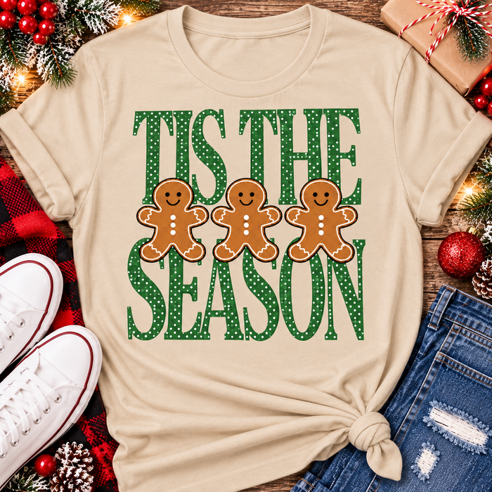 Tis the Season Christmas graphic apparel featuring green polka dot lettering and three gingerbread cookies