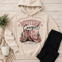 Cream Western Cowgirl hoodie featuring pink cowboy boots, pink cowgirl hat, roses, cacti, desert sunset and Faith Strength Grace graphic.