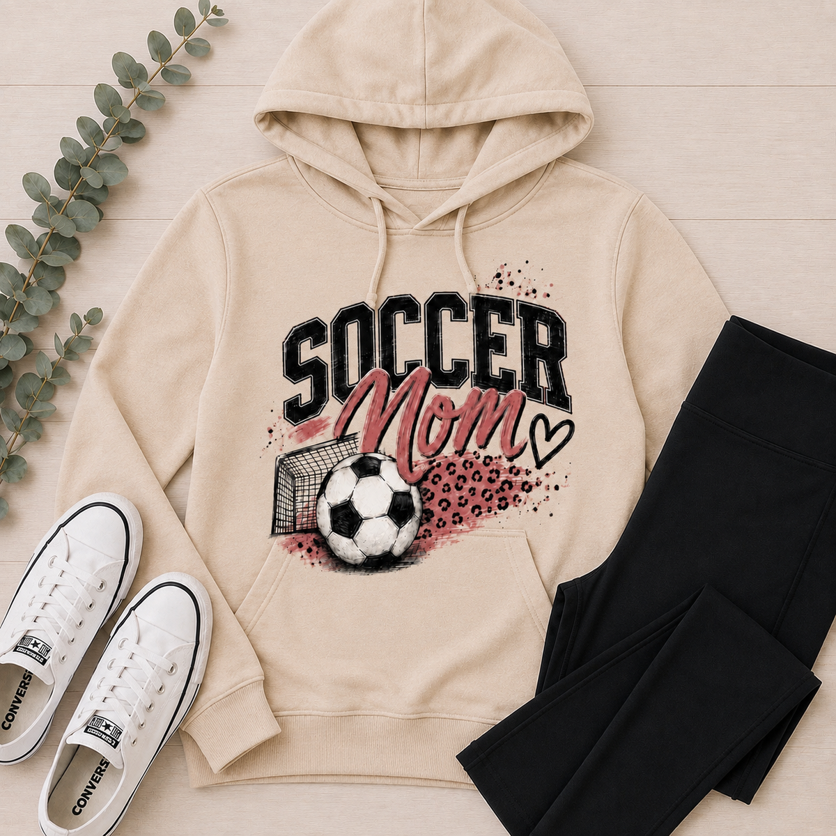 Cream Soccer Mom graphic hoodie featuring pink and black soccer design with leopard print accents.